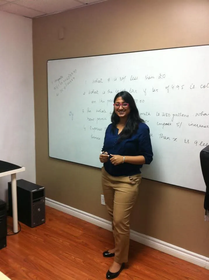 Jasraj teaching at a whiteboard in a college classroom